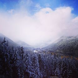 Scenic view of snow covered mountains against sky