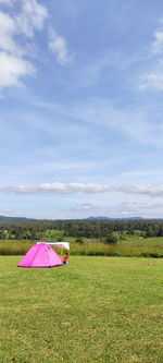 Umbrella on field against sky