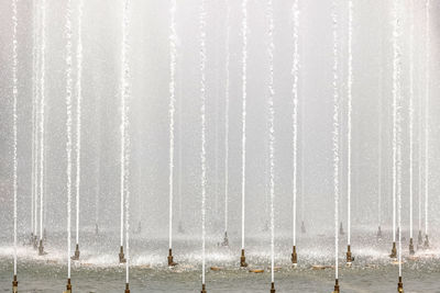 Background of jets and splashes of a fountain in the park.