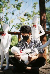 Man sitting with mannequin