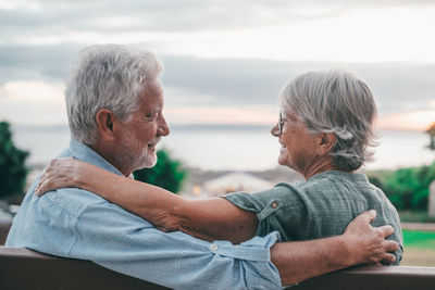 Side view of couple kissing at home