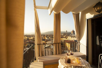 Tables and chairs in restaurant against window