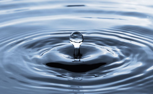 High angle view of drop falling in water