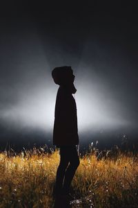 Full length of woman standing on field at night