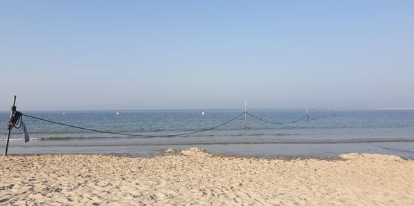 Scenic view of beach against clear sky
