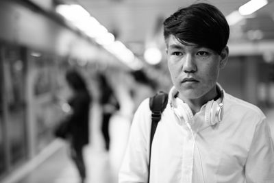 Young man looking away at subway station