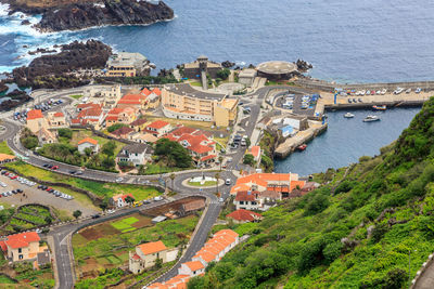 High angle view of townscape by sea