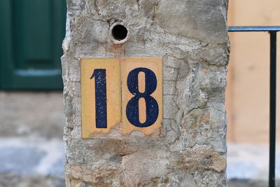 Close-up of information sign on wall