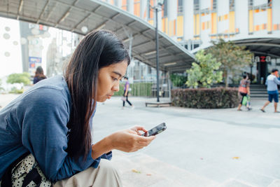 Man using mobile phone in city