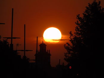 Silhouette building against sky during sunset