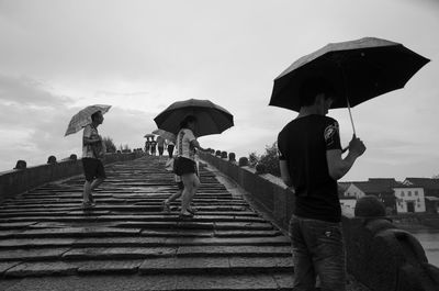 People on steps against sky