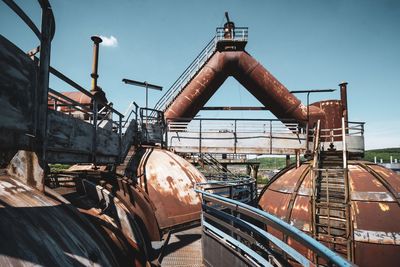 Train in factory against sky