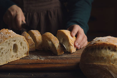 Closeup of homemade bread on table against dark background