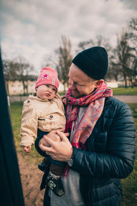 Full length of father with baby in park during winter