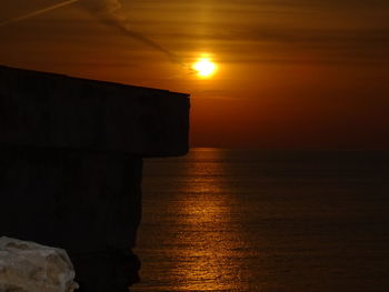 Scenic view of sea against orange sky