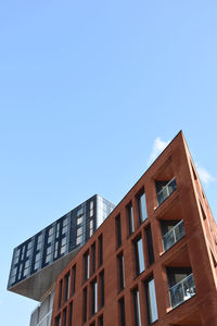 Low angle view of modern building against clear blue sky