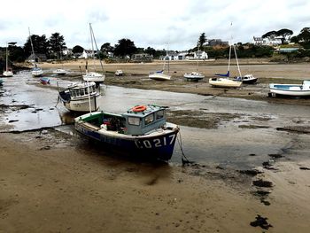 Boats moored on beach