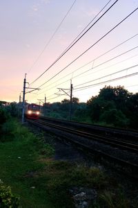 Railroad tracks against sky during sunset