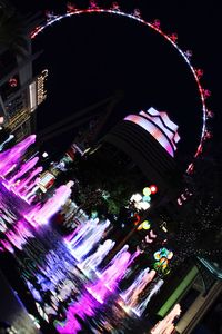 Illuminated ferris wheel at night