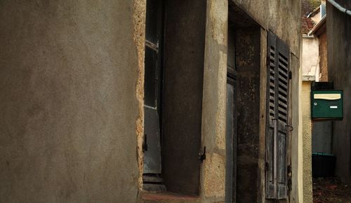 Damaged doors and windows of abandoned building