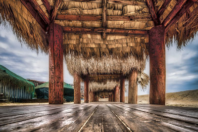 Surface level of empty road with trees in background