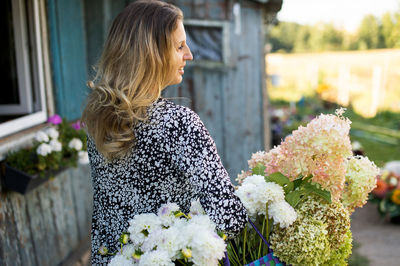 Side view of woman with bouquet