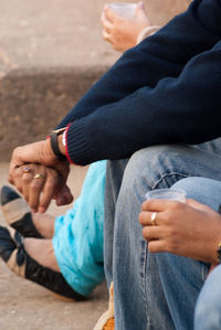 Low section of women sitting outdoors
