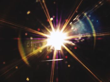 Close-up of illuminated lights against sky at night