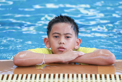 Portrait of boy playing in swimming pool