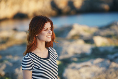 Smiling young woman looking at camera