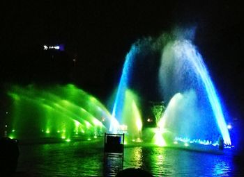 Illuminated fountain at night