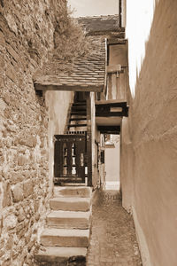 Empty alley amidst buildings