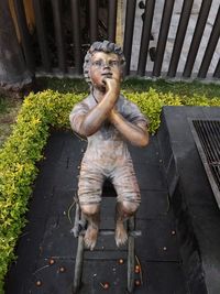 Portrait of man sitting on footpath