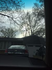 Cars on road against sky in city