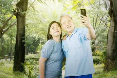 Full length of man photographing with mobile phone