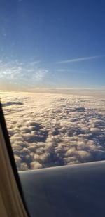 Scenic view of cloudy sky seen through airplane window