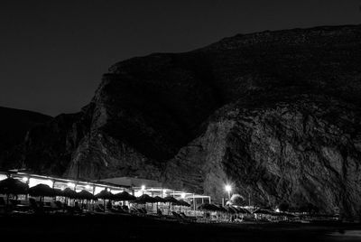 View of illuminated mountains against clear sky at night
