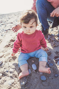 Cute baby girl on sand at beach