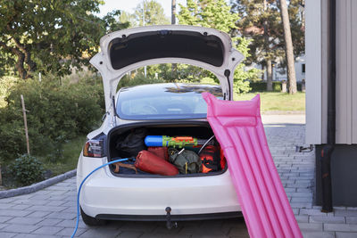 Inflatable raft leaning on electric car