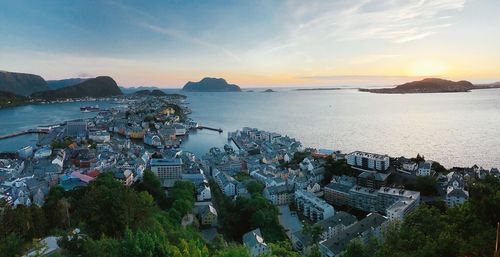 High angle view of city by sea against sky