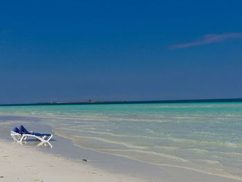 Scenic view of beach against clear blue sky