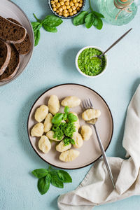 Potato gnocchi with pesto sauce on a plate on the table. italian traditional cuisine. 