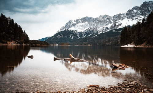 Scenic view of lake and mountains against sky