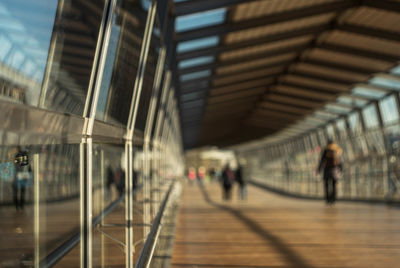 People walking on railway bridge in city