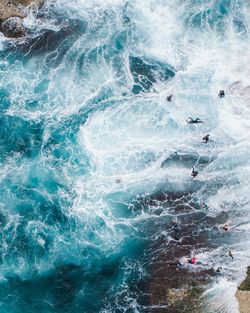 Aerial view of people swimming in sea