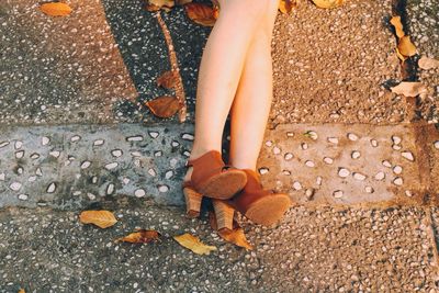 Low section of woman with high heels on street