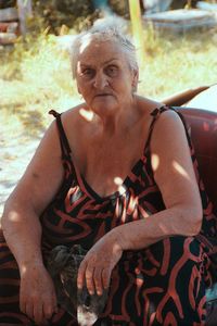 Portrait of woman sitting outdoors