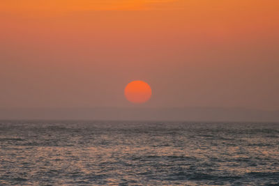 Scenic view of sea against romantic sky at sunset