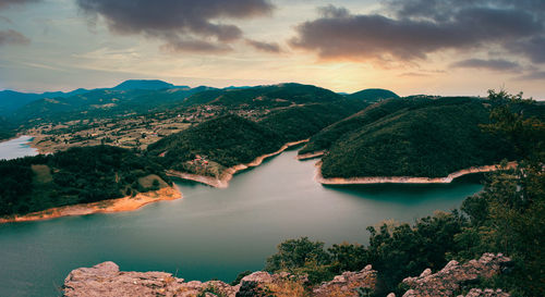 Scenic view of lake and mountains against sky