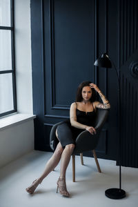 Portrait of young woman sitting on seat